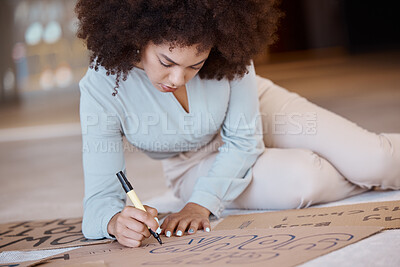 Buy stock photo Black woman, poster and being creative for protest, solidarity with Iran women or prepare for action. African American female, girl and create with cardboard box, draw and for climate change activist