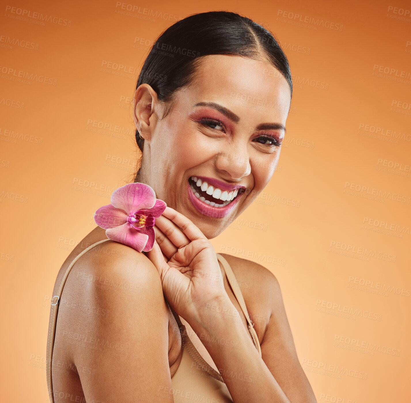 Buy stock photo Skincare, beauty and flower with a model black woman in studio on an orange background to promote a natural product. Cosmetics, face and plant with an attractive young female posing for wellness