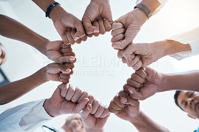 Buy stock photo Corporate diversity, teamwork and fist in circle of group of business employees at office team building motivation event. Staff collaboration, professional community and fist bump to support mission 