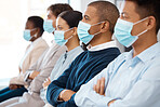 Covid, face mask and people at a business convention sitting in row. Healthcare, networking and audience wearing mask at conference, seminar or trade show during covid 19 pandemic in corporate office