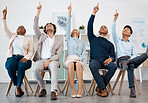 Business people, team and hands raised for asking question during workshop, training or meeting. Collaboration, teamwork and goal with crowd pointing up to volunteer, praise or show advertising idea