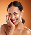 Skincare, beauty cream and woman with cream on face product against a orange mockup studio background. Happy and smile model with cosmetics for skin, body wellness and cosmetology or dermatology