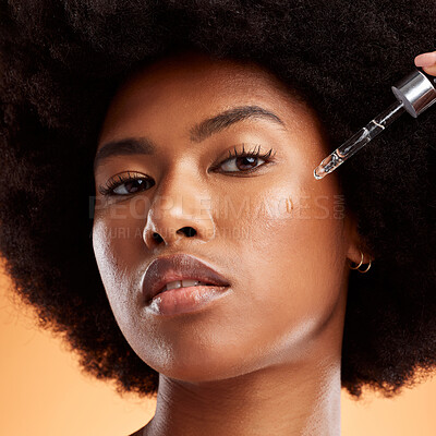 Buy stock photo Oil, skincare and black woman with product for face against an orange studio background. Portrait of a young, African and cosmetic model with liquid serum for facial health, skin beauty and wellness