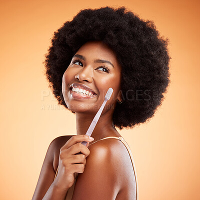 Toothbrush, dental and black woman with smile for teeth against a mockup orange studio background. Young, African and thinking model with wellness and health results from cleaning mouth with product