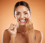 Woman, dental flossing and teeth with smile for clean hygiene  and health against a studio background. Portrait of a happy toothy woman smiling in beauty floss for hygienic mouth, oral and gum care