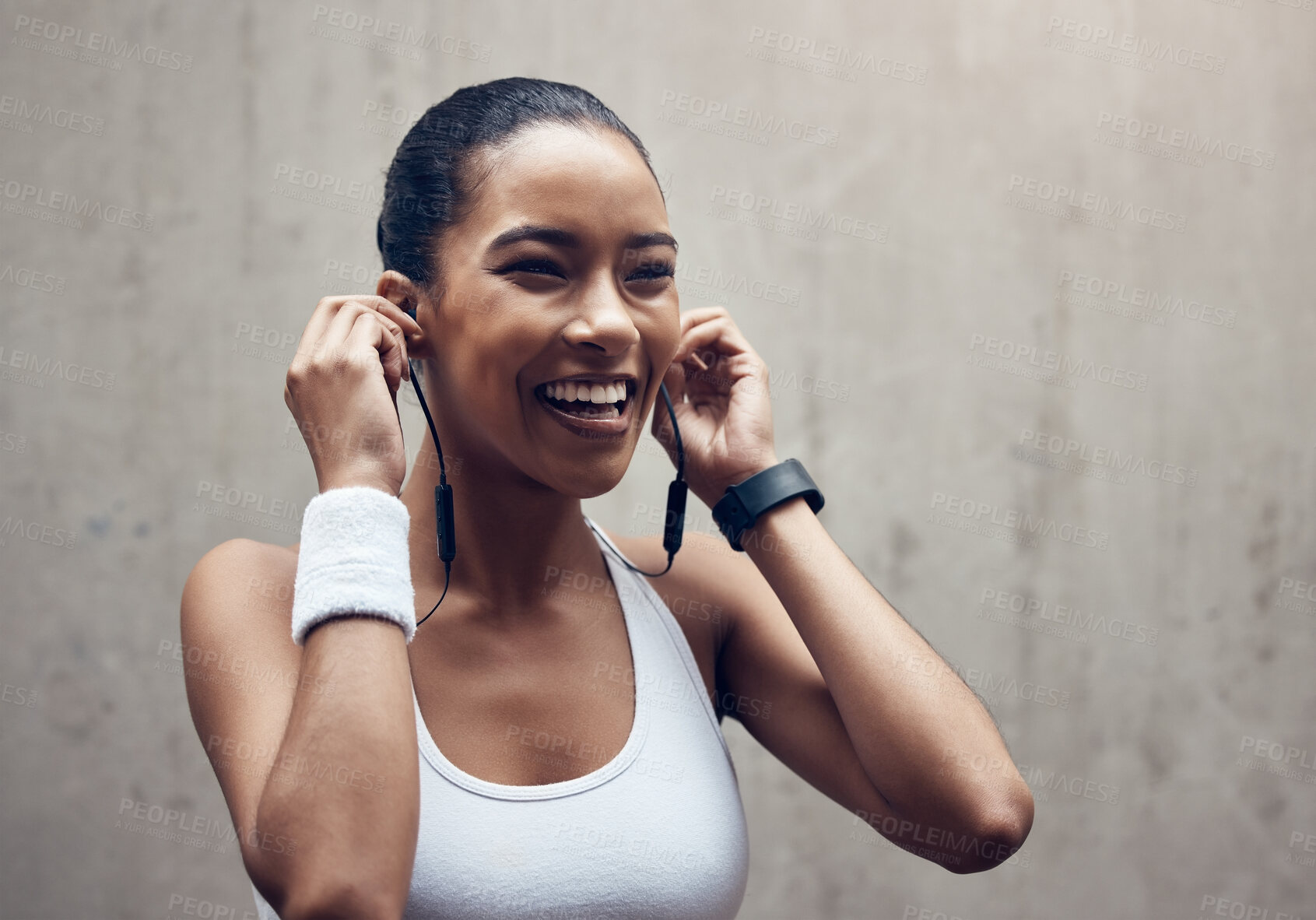 Buy stock photo Music, fitness and exercise with a sports woman streaming audio during training or a workout on a gray background. Health, cardio and training with a female runner listening on earphones during a run