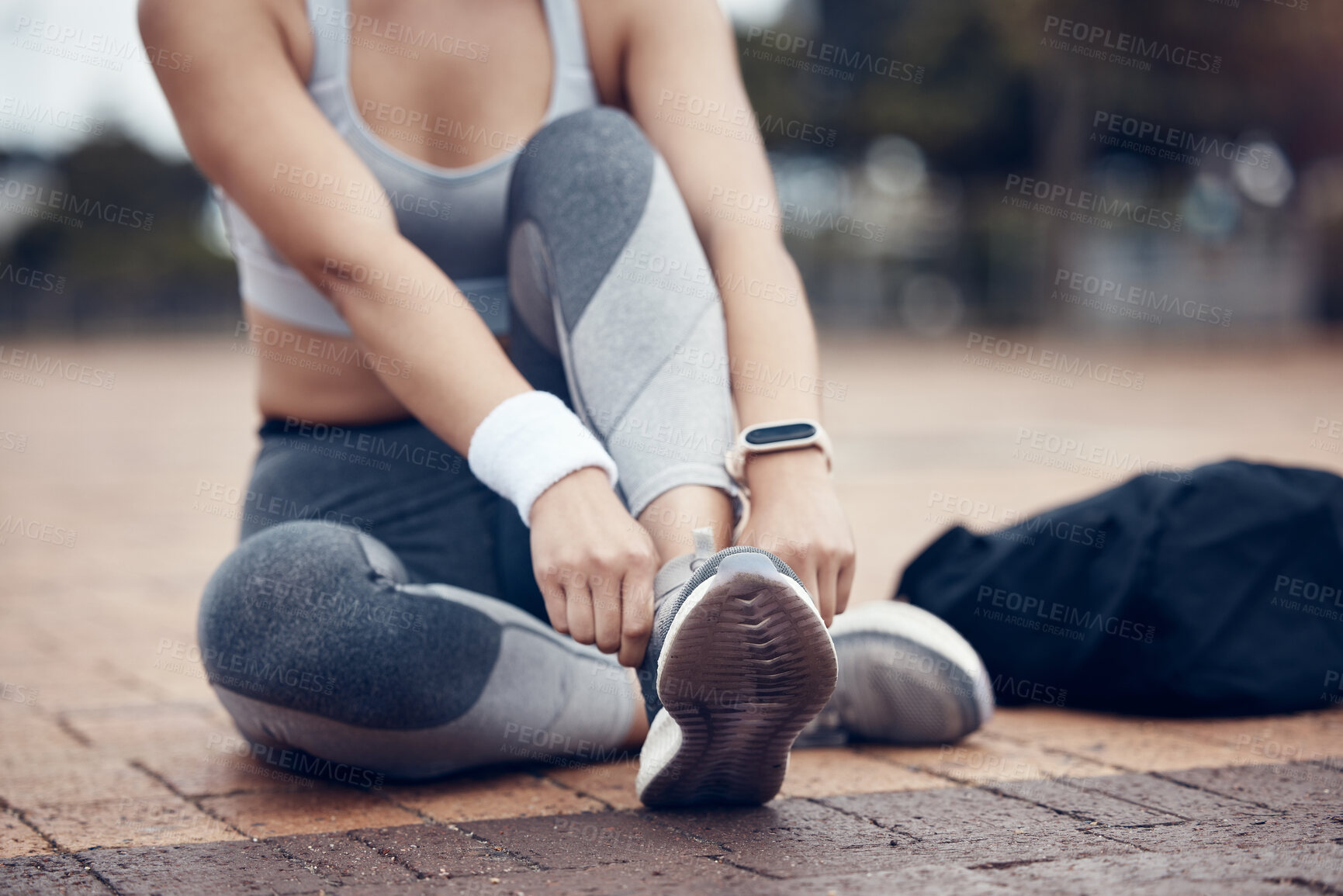 Buy stock photo Workout, fitness and woman tying shoes on feet, sitting on ground before marathon training or running. Health, wellness and sports footwear, motivation for exercise for girl athlete or track runner.