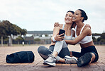 Workout, happy and friends with phone on floor after fitness training in the city of New York together. Runner and black woman talking about funny 5g mobile app after health exercise outdoor