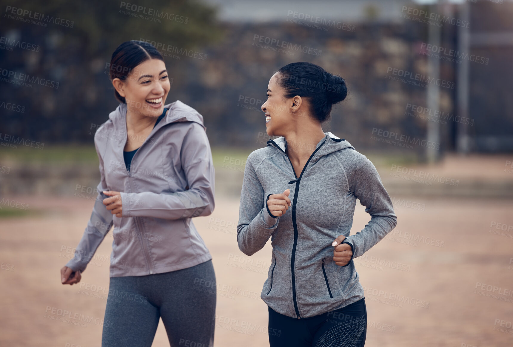 Buy stock photo Women, friends and running in city, street or outdoors for fitness, health and wellness. Exercise, diversity and happy girls out for a run, workout or training and talking, speaking or chat together.