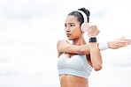 Arms, stretching or music headphones for fitness woman motivation in Indonesian workout, sweat training or exercise. Sports, personal trainer or runner listening to health podcast and wellness radio 