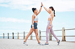 High five, fitness and women training in the city with support for body goal, health and wellness. Young, happy and excited runner friends with motivation for exercise, running and outdoor workout