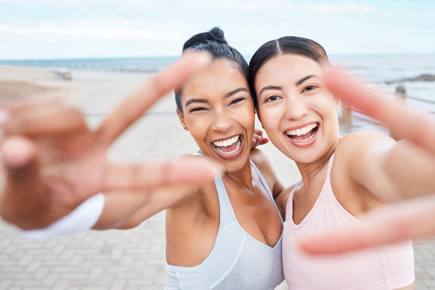 Buy stock photo Running, fitness and women taking a selfie with peace hand sign by the sea. Wellness, healthy lifestyle and portrait of young friends doing workout, training and exercise, taking a picture together