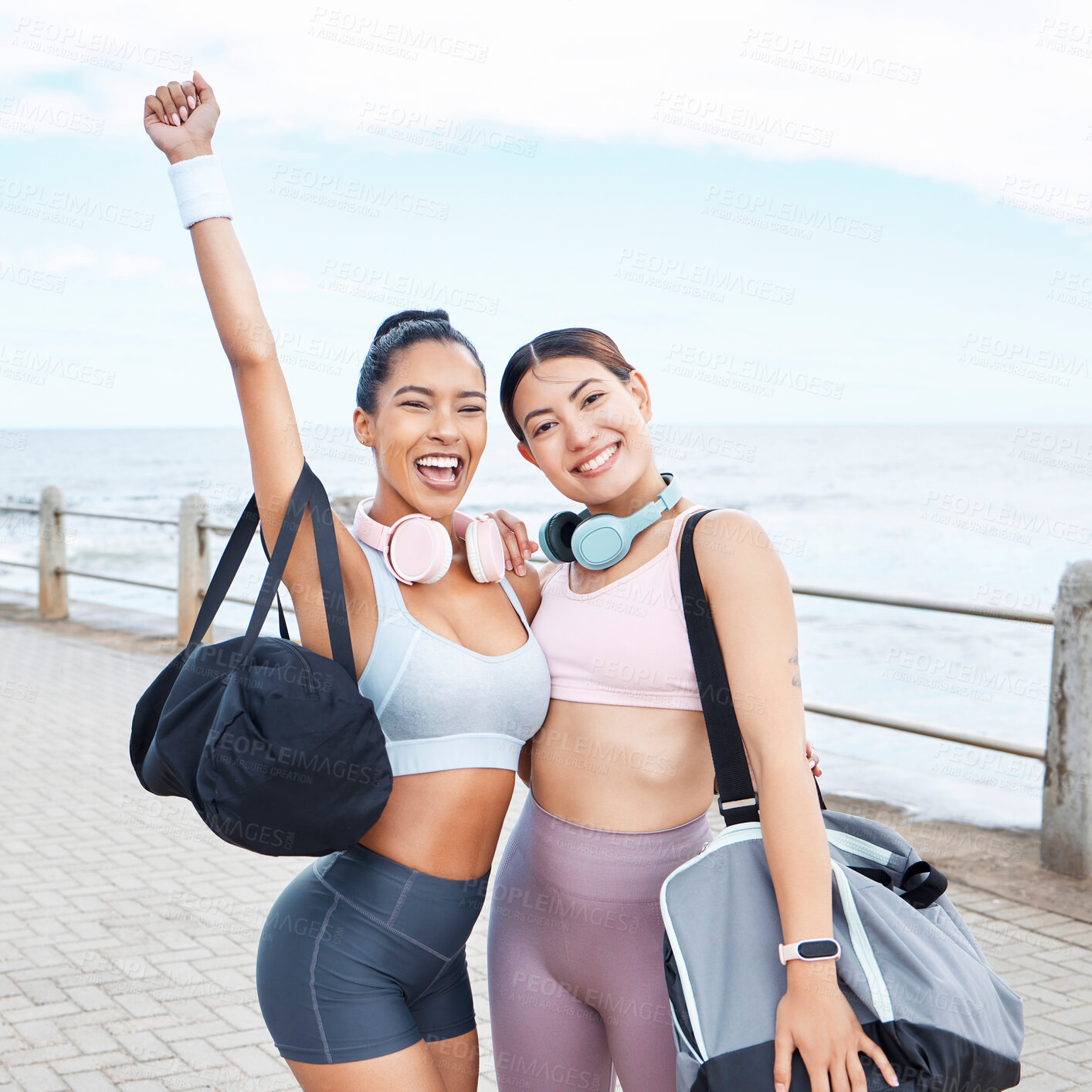 Buy stock photo Excited, fitness success and friends exercise by ocean for outdoor training wellness, accountability and happy with body results. Happy sports women with workout bag and headphones for motivation