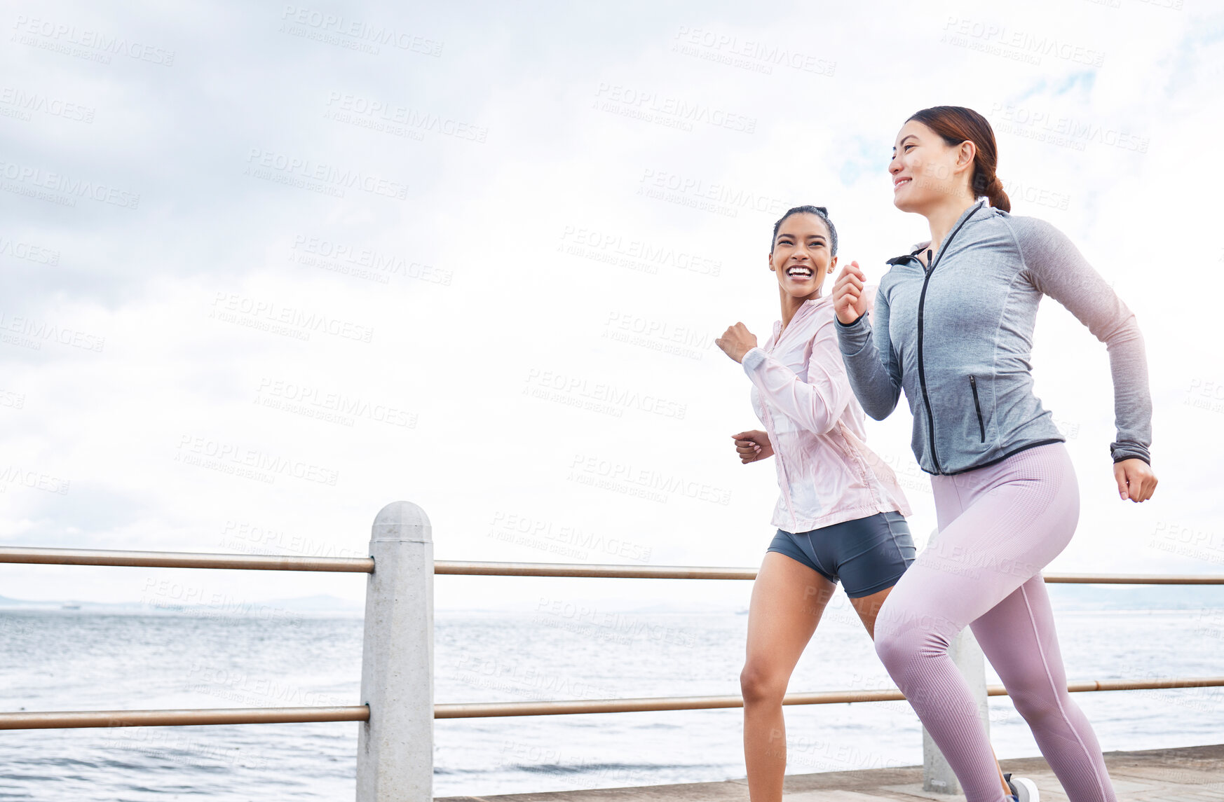 Buy stock photo Running, fitness and friends, women run by the beach, exercise and cardio, endurance and active lifestyle. Young, happy people, runner and health, body training motivation and workout outdoors.