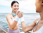 Handshake, beach and happy fitness friends excited with training targets, exercise and workout goals outdoors. Smile, happiness and healthy women with girl power shaking hands with pride and joy 