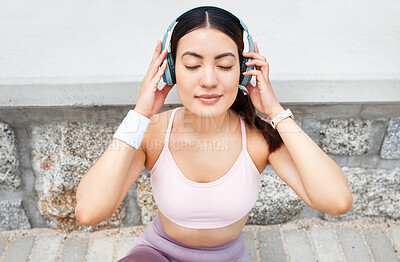 Buy stock photo Fitness, music and woman with headphones sitting on ground to relax after outdoor workout, running or yoga. Sports, exercise and streaming motivation or meditation app and enjoying calm playlist.