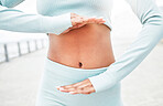 Fitness, woman and hands on stomach for digestion health with workout, exercise and training. Gut health, weight loss or diet of active runner girl showing healthy abdomen on cardio break. 

