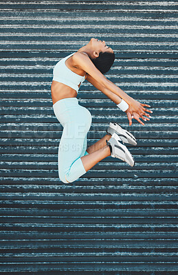 Buy stock photo Fitness, health and woman jump in city, street or outdoors for exercise, training or wellness. Freedom, energy and happy female from India leap, spring or jumping high in air for sports or workout.