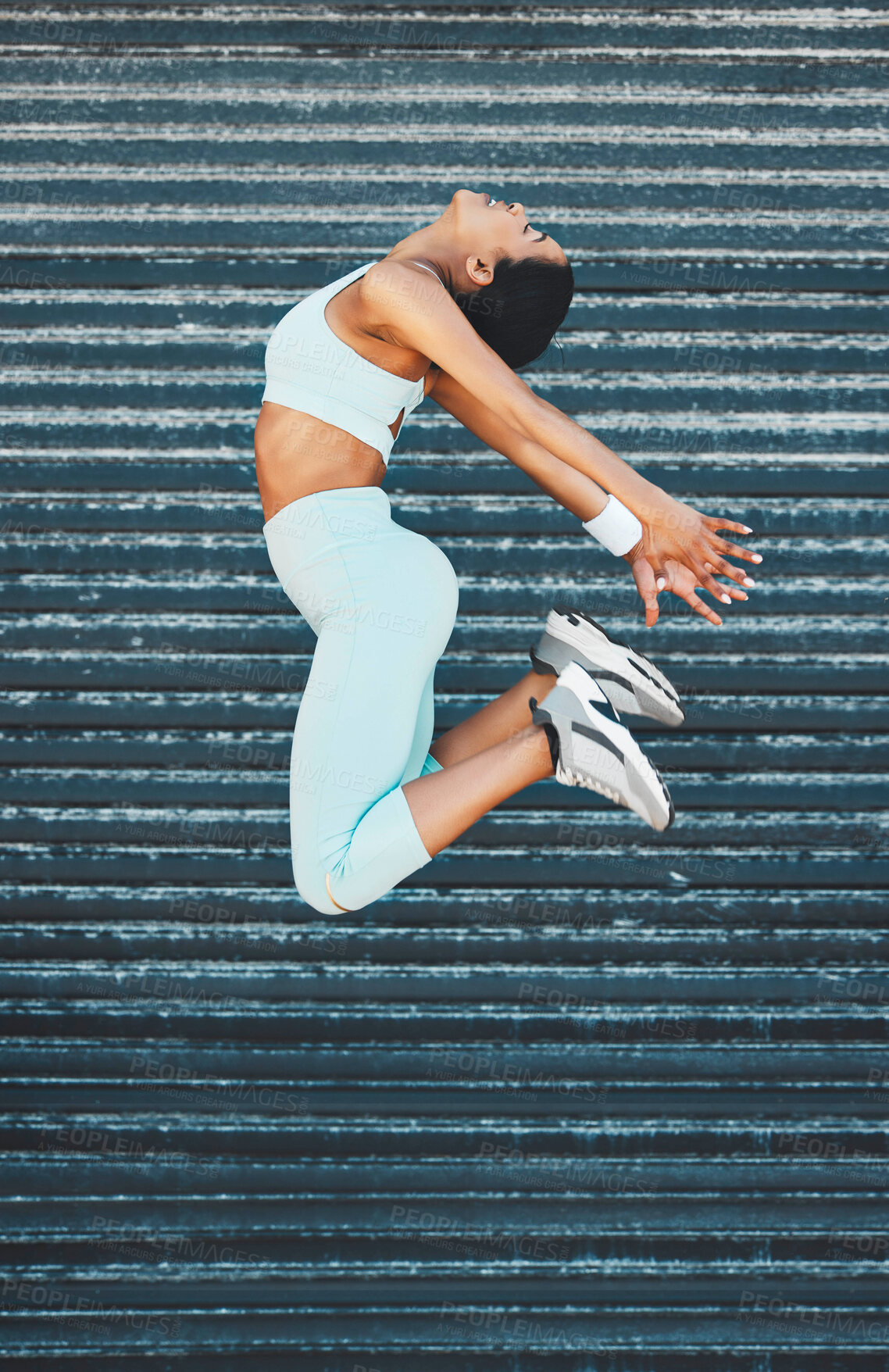 Buy stock photo Fitness, health and woman jump in city, street or outdoors for exercise, training or wellness. Freedom, energy and happy female from India leap, spring or jumping high in air for sports or workout.