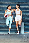 Fitness women, friends and yoga mat practice looking fit, slim and happy about exercise, training and workout standing against an urban background. Females together for aerobics, health and wellness
