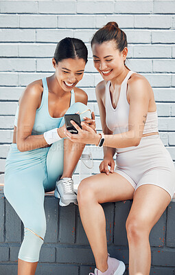 Buy stock photo Women, phone and laughing after city fitness, training and exercise for health, wellness or cardio health. Smile, happy or funny sports friends, people and runners with social media mobile technology