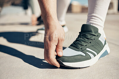 Buy stock photo Shoes, hand and stretching with a sports man touching his toes during an exercise or fitness warmup in the city. Health, training and workout with a male athlete getting ready for competition closeup