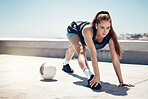 Soccer ball, stretching and woman in fitness workout, training and exercise on rooftop with music earphones. Football player, sports person and athlete listening to motivation podcast or health radio