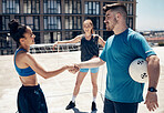 Handshake, volleyball and outdoor with man, women and city in sport with respect, equality or empowerment. People, sports and city for fitness, exercise and wellness for summer in workout by building