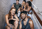 Fitness, phone and group of friends on stairs networking on social media together after gym workout. Happy, smile and sports people sitting and watching funny comic videos on internet with smartphone