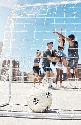 Football, soccer team and ball in goal post or net with diversity sports group of men and women in celebration of win, winning and scoring on urban rooftop. Exercise, concrete training and champions