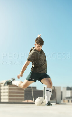Buy stock photo Man, soccer ball and kick in city for goal, shooting or workout on rooftop of building, urban or metro. Soccer player, football and striker at training, exercise and fitness in sports in summer sun