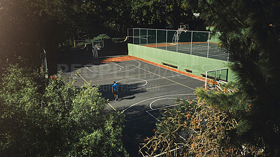 Buy stock photo Drone, aerial view of basketball court and basketball player man preparing for training match, game or competition. Sports court, practice and workout or exercise preparation outdoors from above.