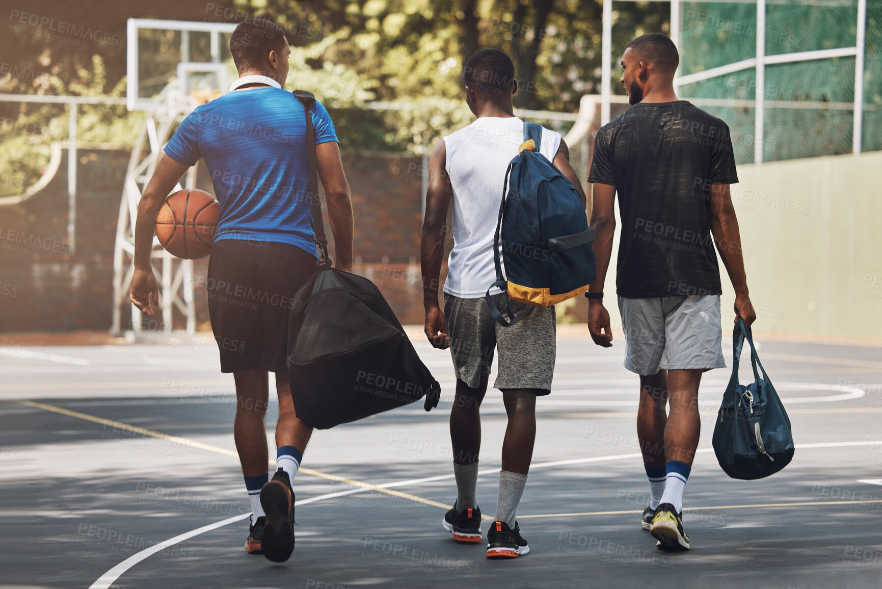 Buy stock photo Sports, Basketball and team walking to training workout on basketball court outdoors. African athlete men talking, fitness exercise and healthy sport teamwork with ball practice for competition