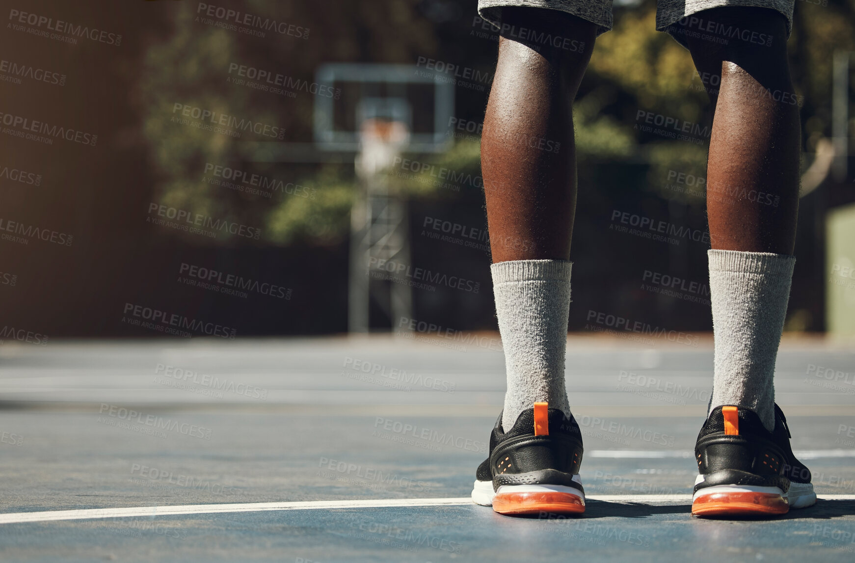 Buy stock photo Basketball, sneakers and athlete black man standing on community sports court for match, motivation and streetball memory. Male player outside in USA with sport shoes on feet for fitness and exercise