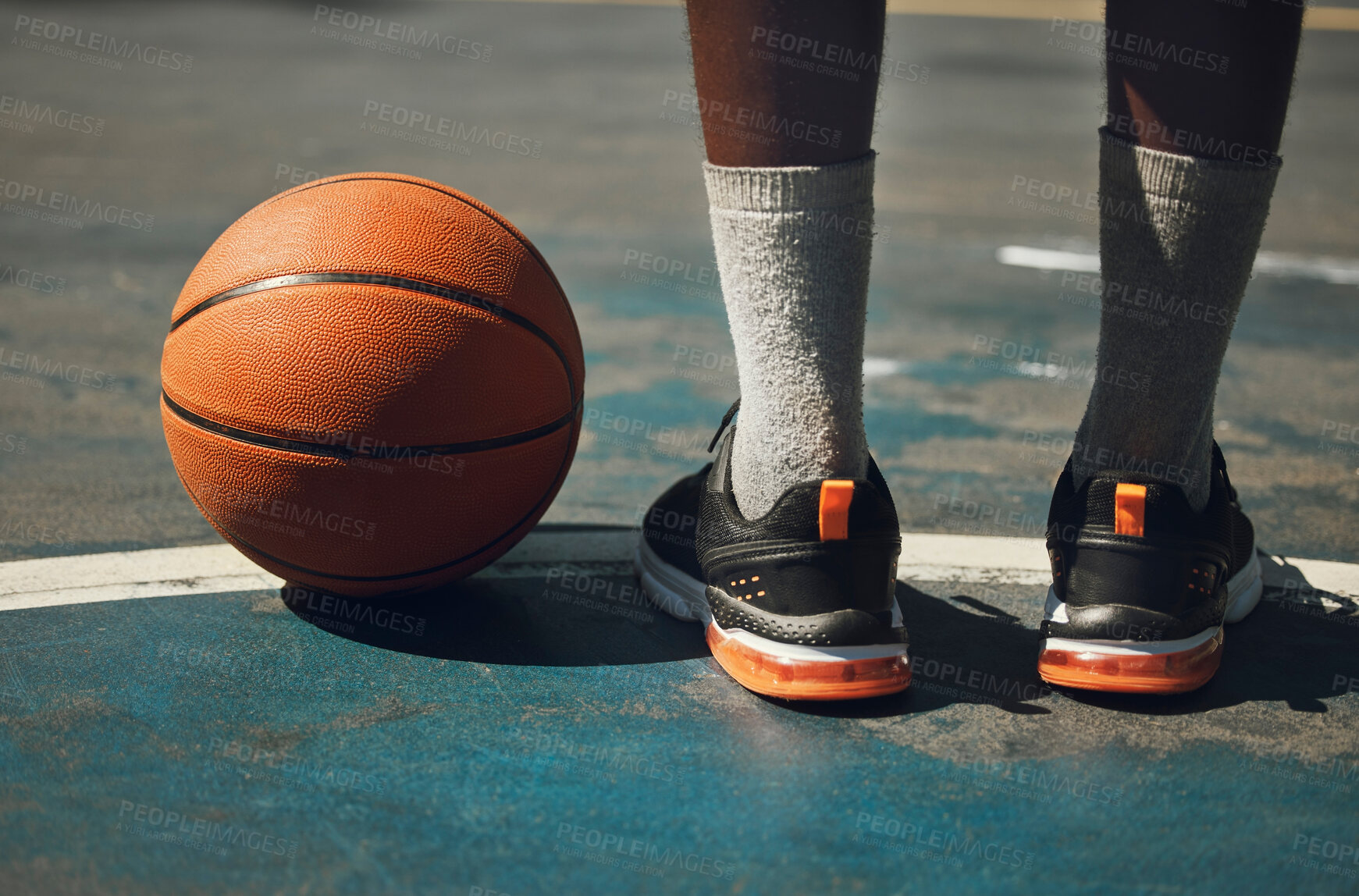 Buy stock photo Basketball, basketball player and athlete legs close up on basketball court outdoors fitness training workout. Young African American man, sports exercise and healthy lifestyle motivation outside