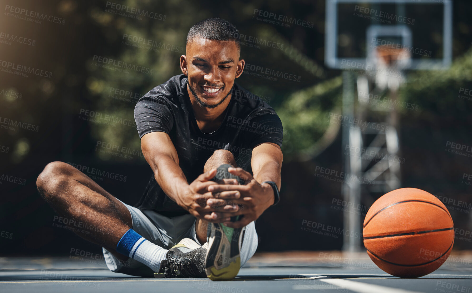 Buy stock photo Training, basketball player and man stretching legs in outdoor community court, muscle energy and healthy sports game performance. Happy, strong and young male athlete warm up exercise in competition