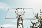 Basketball, sports and fitness with a hoop on a court for a game, match or competitive event outdoor from below. Exercise, training and net with sport equipment outside on a clear blue sky summer day