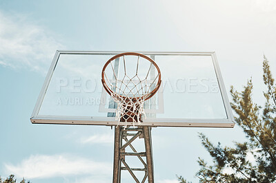 Buy stock photo Basketball, sports and fitness with a hoop on a court for a game, match or competitive event outdoor from below. Exercise, training and net with sport equipment outside on a clear blue sky summer day