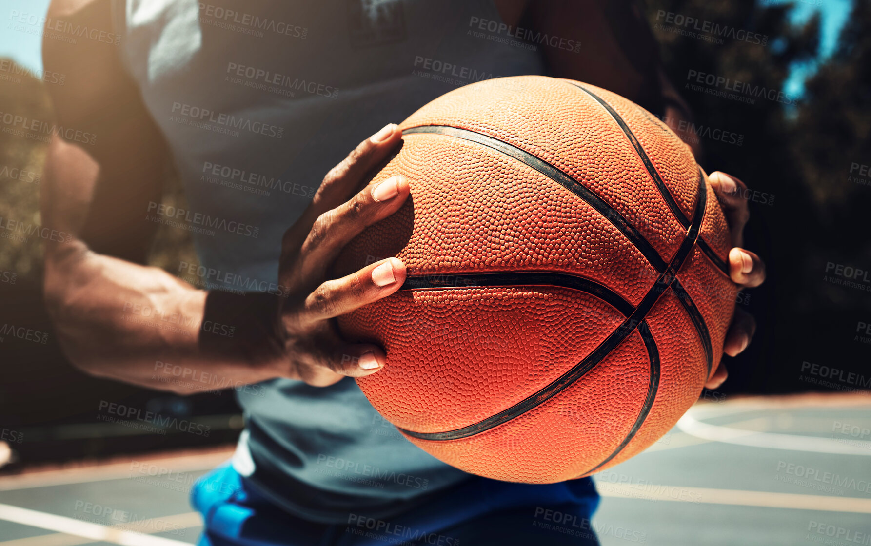 Buy stock photo Basketball, basketball player and athlete hands closeup holding ball on basketball court in urban city park outside. African man, sports fitness and healthy lifestyle wellness training outdoors