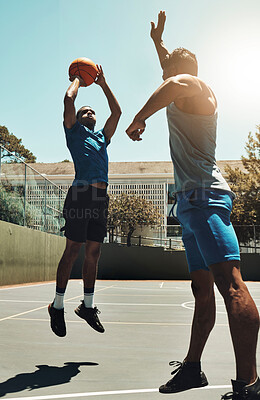 Basketball, sports game and man shooting for goal, fitness exercise and training workout on outdoor basketball court. Street competition, winner mindset and healthy athlete jump and playing match