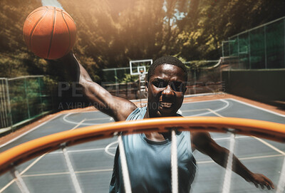 Basketball, sports goal and man training at basketball court with ball, jump and dunk skill practice. Energy, fitness and power by athletic black man focused on winning target during exercise workout