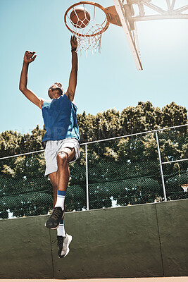 Buy stock photo Basketball, sport and man jump dunk a ball into the net during a match on a sports court. Fit and active athlete jumping to score during a training game. Healthy athletic african man in action
