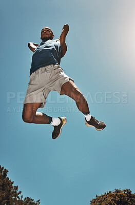 Buy stock photo Sports, blue sky and basketball man jump for game, competition or slam dunk training, practice or workout. High energy, athlete motivation and basketball player doing fitness or exercise bottom view