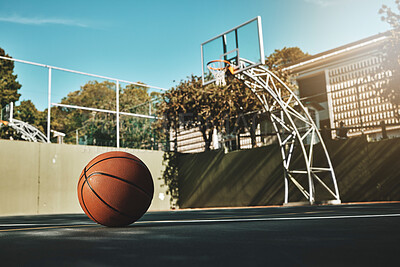 Basketball, outdoor and court with ball on floor for athletic competition or recreation low angle. Exercise, cardio and basketball court ground with basket board for sports, match or workout.