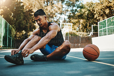 Buy stock photo Basketball court, man and shoes prepare for training at recreation and athlete facility. Sports, exercise and fitness male with lace tie getting ready for ball game workout and cardio.

