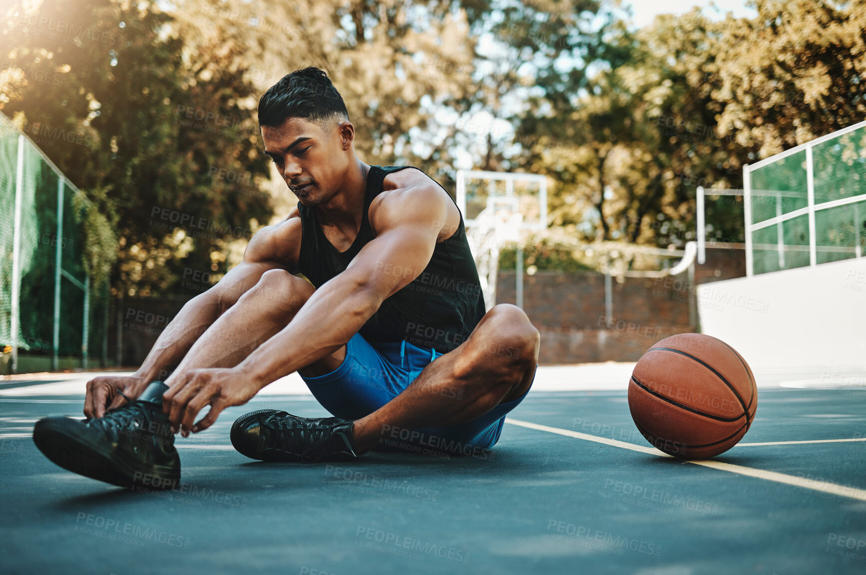 Buy stock photo Basketball court, man and shoes prepare for training at recreation and athlete facility. Sports, exercise and fitness male with lace tie getting ready for ball game workout and cardio.

