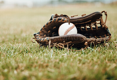 Buy stock photo Baseball, sport and ball with glove on a grass pitch or field outdoor for a competitive game or match. Fitness, sports gear and skill with equipment on the ground for training, practice and game