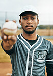 Baseball, sports and ball with a black man athlete on a grass pitch or field before a game for fitness and exercise. Training, workout and health with a male baseball player ready for a game outside