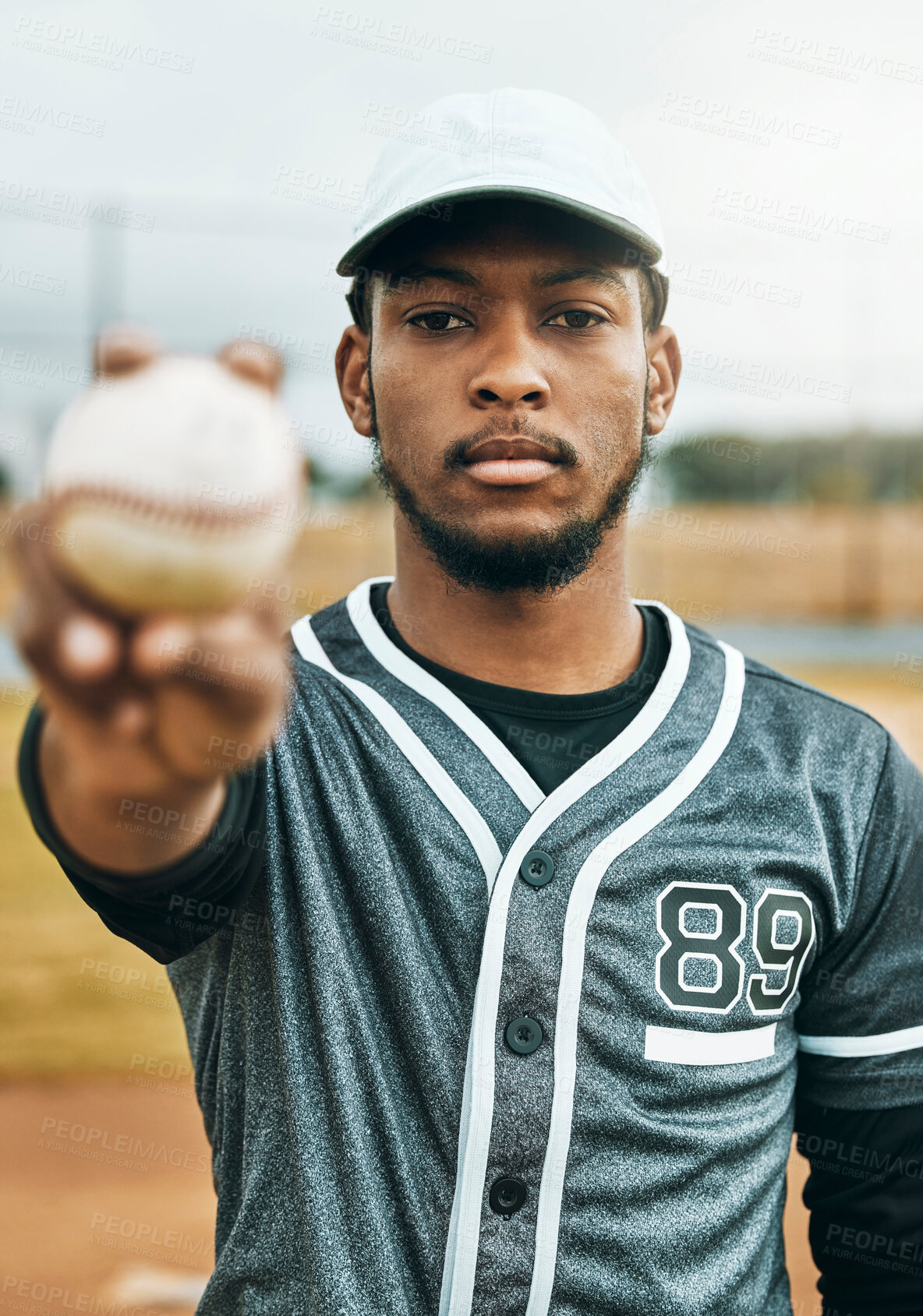Buy stock photo Baseball, sports and ball with a black man athlete on a grass pitch or field before a game for fitness and exercise. Training, workout and health with a male baseball player ready for a game outside