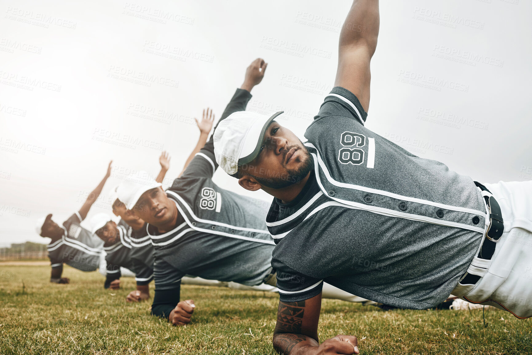 Buy stock photo Baseball, sports and collaboration with a team stretching for a game or match on a field. Sport, fitness and exercise with a male athlete group in a warmup before training on grass for a workout